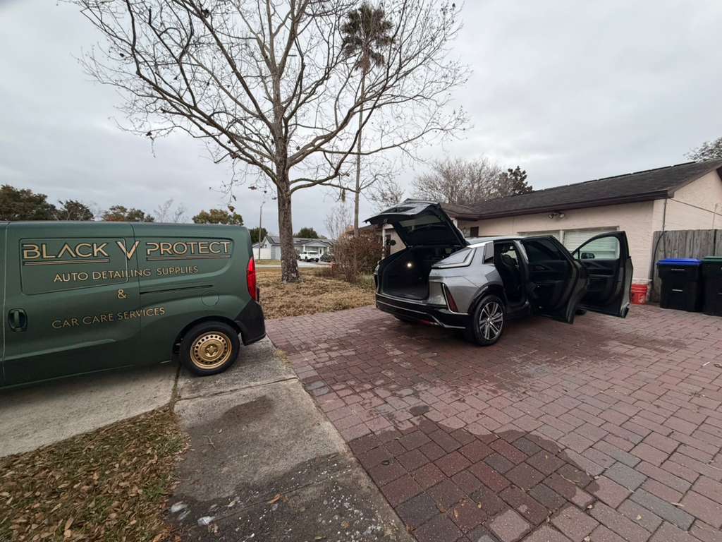 Black V Protect mobile detailing van at customer home — Cadillac Escalade Orlando